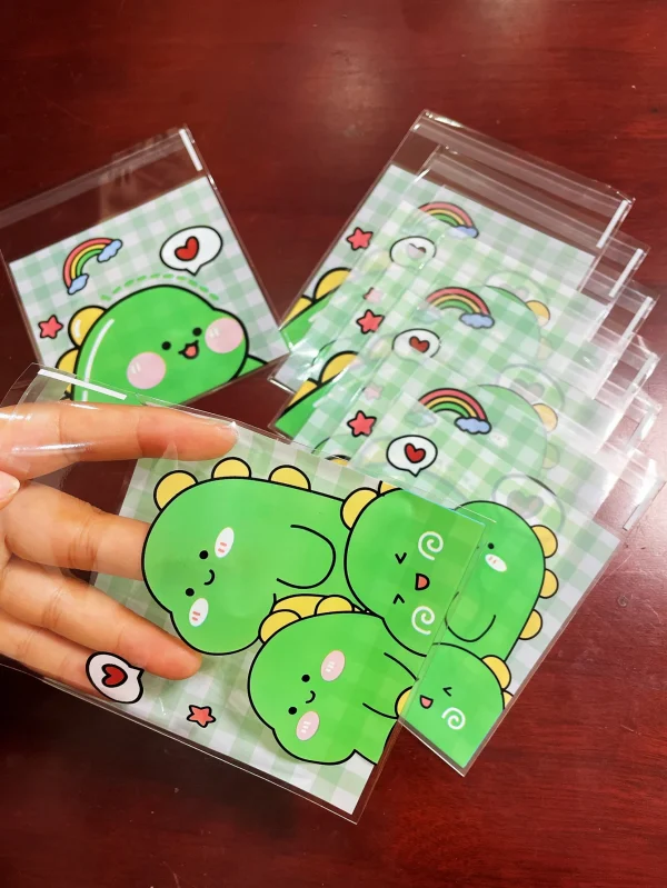 100pcs Green Dinosaur Graffiti Gift Packaging OPP Self-Sealing Bag, Green Grid Heart Rainbow Pattern Gift Card Decor OPP Bags 1