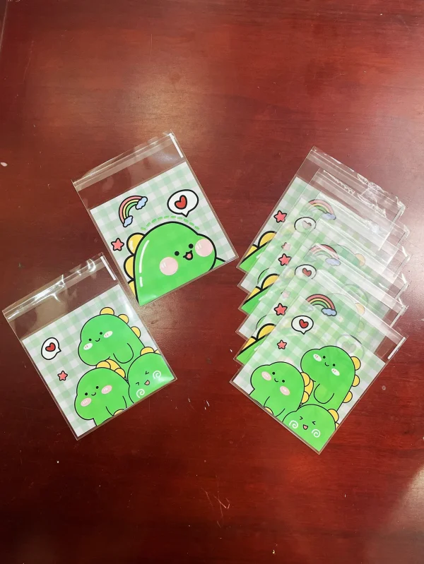 100pcs Green Dinosaur Graffiti Gift Packaging OPP Self-Sealing Bag, Green Grid Heart Rainbow Pattern Gift Card Decor OPP Bags 4